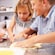 A group of kids making pizza